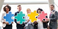5 Business People Holding Puzzle Pieces In Front of Them - Kathbern Management Toronto Recruiting Firm