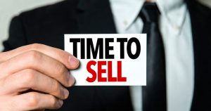 A Business Person Holding A Sign Saying Time To Sell - Kathbern Management Toronto Recruiting Agency